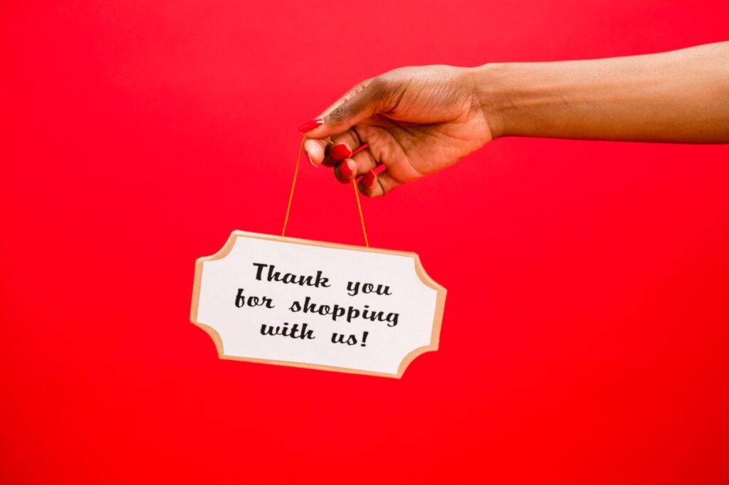 person holding a board with a text saying thank you for shopping with us