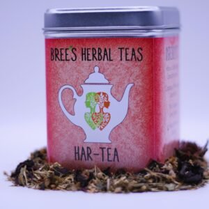 Herbal tea to promote heart health in a red tin surrounded by herbal tea with a white background