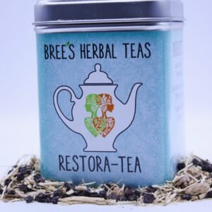 Immune boosting Herbal tea in a tin surrounded by loose herbs with a white background