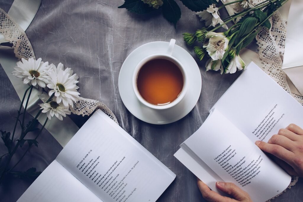 Antioxidant rich green tea in a cup with a person reading a book