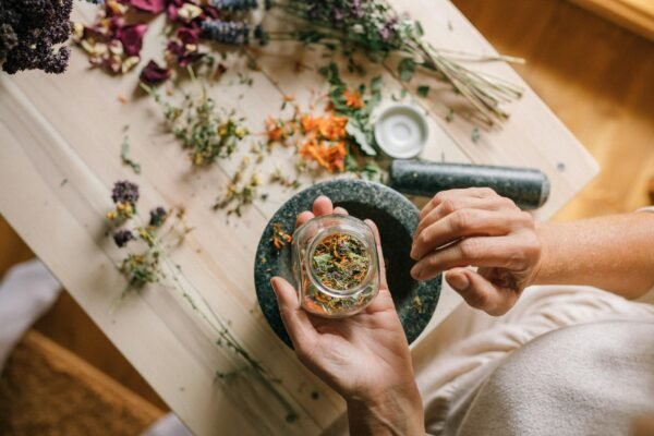 person holding gold ring with clear gemstone